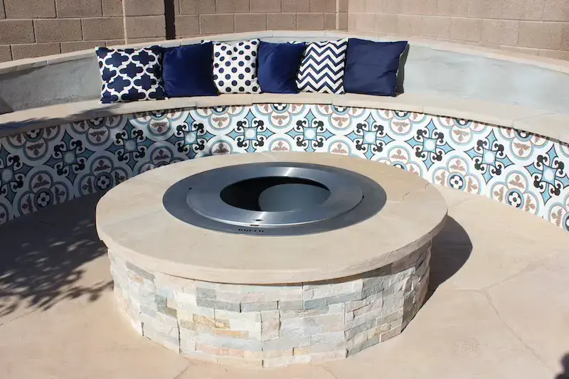 view of a fire pit and sitting bench